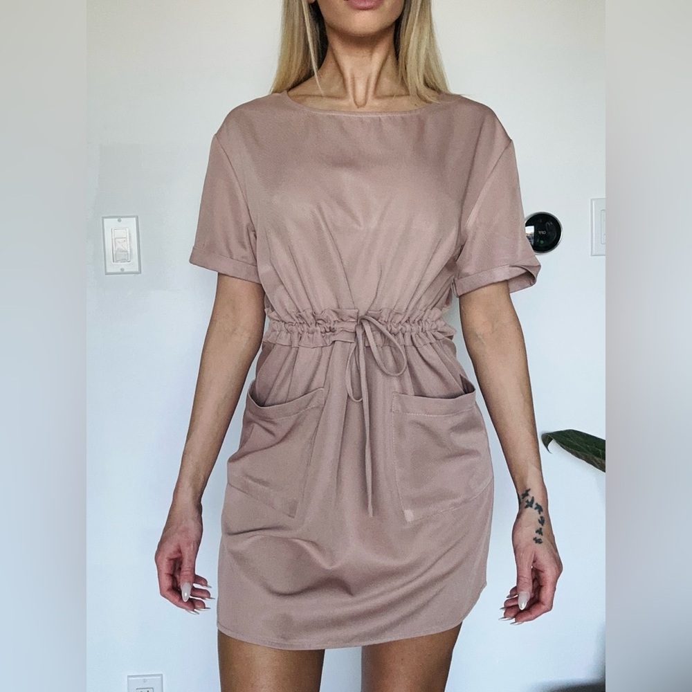 Mauve pink, short sleeve mini dress adorned with pockets & a tie waiste